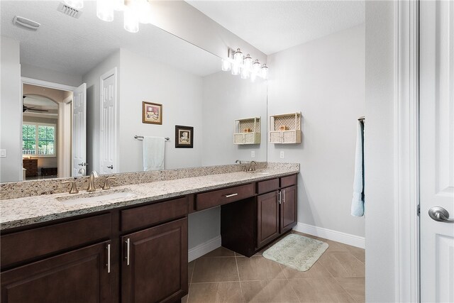 bathroom featuring vanity, a textured ceiling, and tile patterned floors