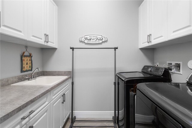 laundry room with cabinets, sink, tile patterned floors, and washer and dryer