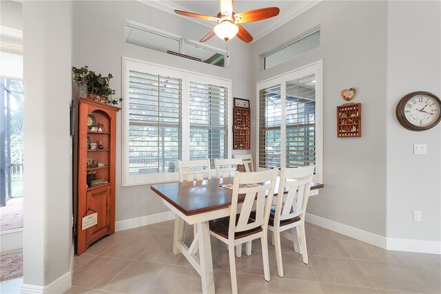 tiled dining area featuring a healthy amount of sunlight and crown molding