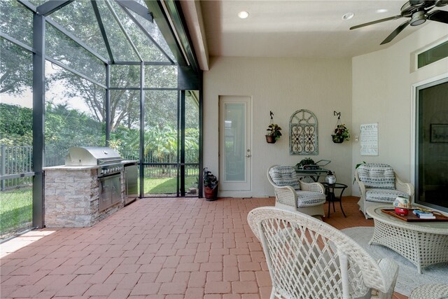 sunroom with a wealth of natural light and ceiling fan