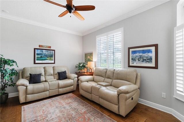 living room with dark hardwood / wood-style flooring, ceiling fan, and crown molding