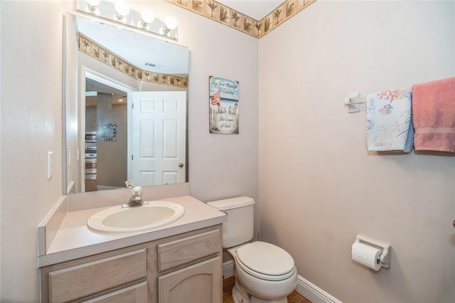 bathroom with vanity and toilet