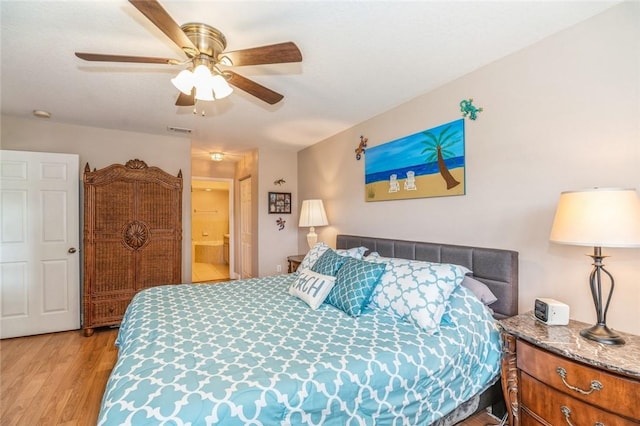 bedroom featuring connected bathroom, ceiling fan, and light hardwood / wood-style floors