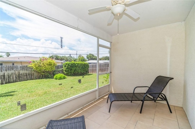 sunroom featuring ceiling fan