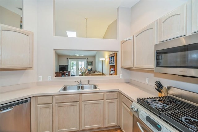 kitchen featuring ceiling fan, sink, french doors, stainless steel appliances, and light brown cabinets