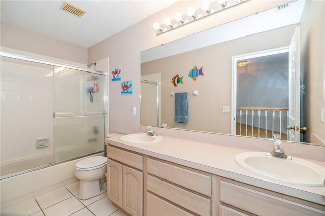 full bathroom with tile patterned flooring, vanity, toilet, and combined bath / shower with glass door