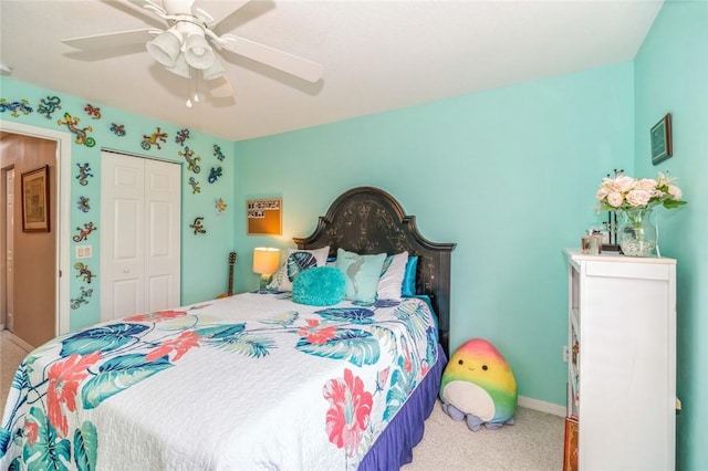 carpeted bedroom featuring ceiling fan and a closet