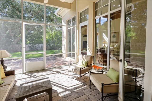 sunroom / solarium featuring ceiling fan