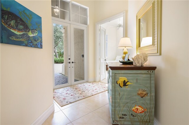 doorway to outside featuring ceiling fan, light tile patterned floors, and french doors