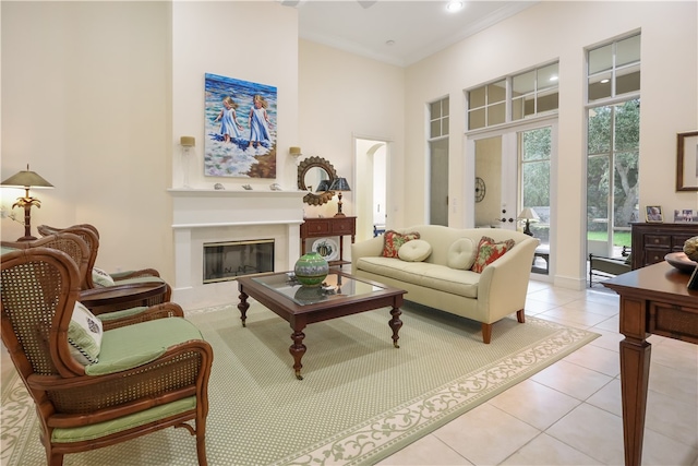 tiled living room with ornamental molding and a towering ceiling