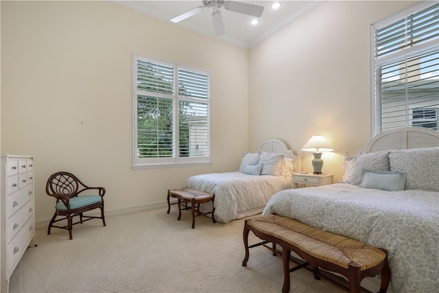 bedroom with ceiling fan, crown molding, and light colored carpet