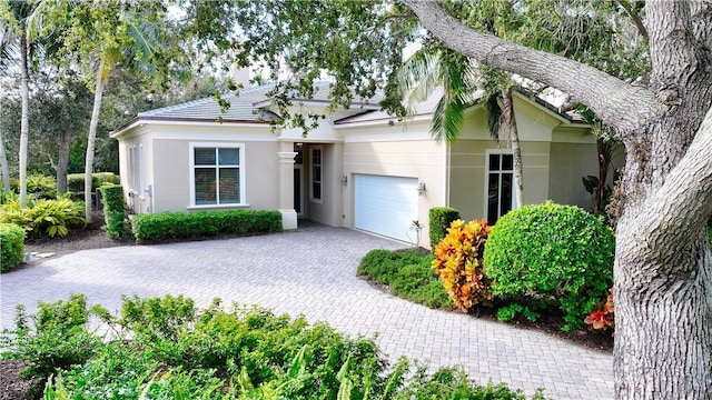 1632 Weybridge Cir, Vero Beach, FL 32963 - ranch-style house with an attached garage, decorative driveway, and stucco siding