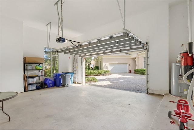 garage featuring electric water heater and a garage door opener