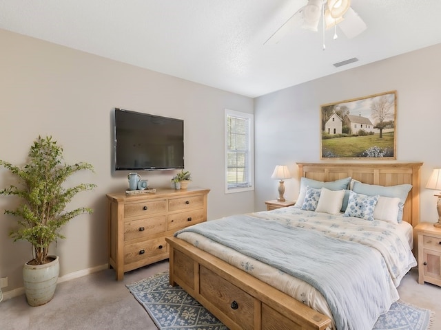 bedroom featuring light colored carpet and ceiling fan