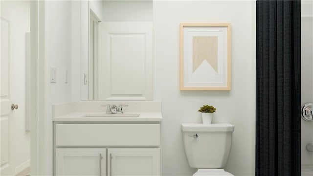 bathroom with toilet and vanity