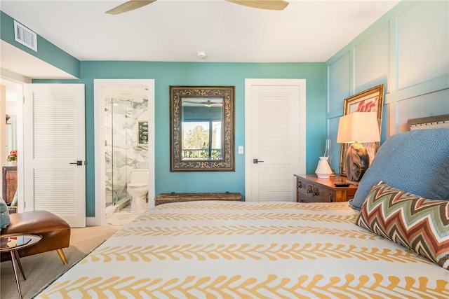 bedroom with visible vents, carpet flooring, and ensuite bathroom