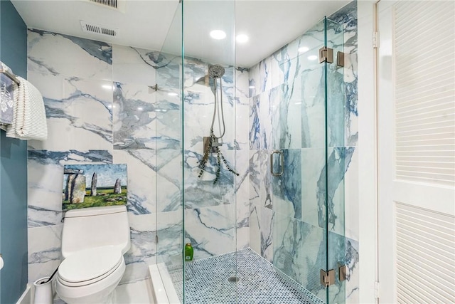 bathroom with toilet, visible vents, and a marble finish shower