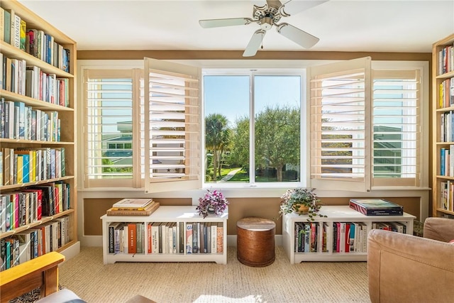 sitting room featuring carpet floors and a ceiling fan