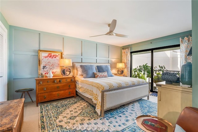 carpeted bedroom featuring a decorative wall and ceiling fan