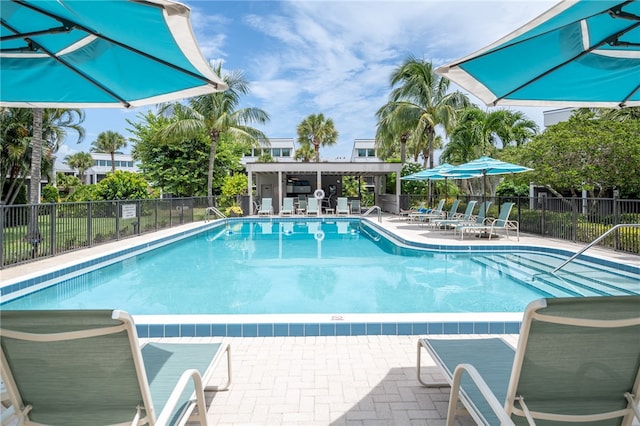 community pool featuring a patio and fence