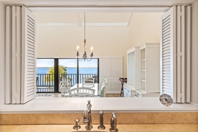 interior space featuring an inviting chandelier and a water view