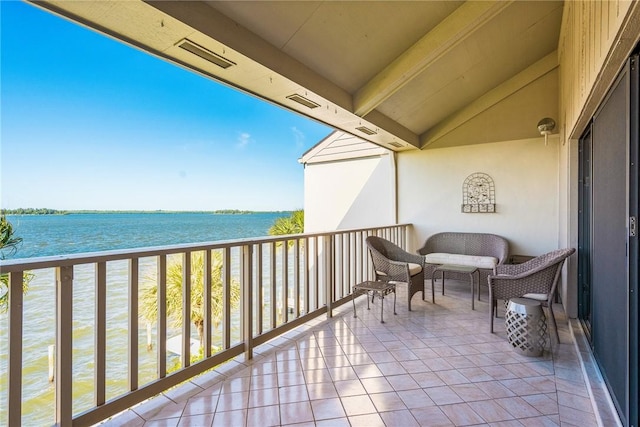 balcony featuring outdoor lounge area and a water view