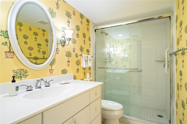 bathroom with visible vents, toilet, a stall shower, and wallpapered walls