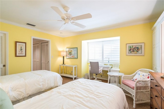 bedroom with visible vents, crown molding, a closet, a ceiling fan, and dark colored carpet