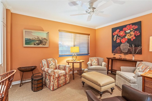 sitting room featuring ceiling fan, crown molding, baseboards, and light carpet