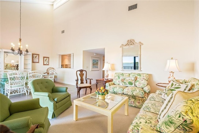 living room with a chandelier, visible vents, and wood finished floors