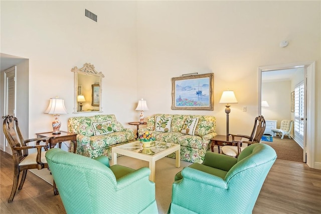 living room with visible vents and wood finished floors