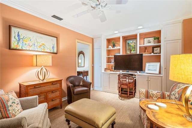 sitting room featuring visible vents, built in shelves, a ceiling fan, crown molding, and light colored carpet