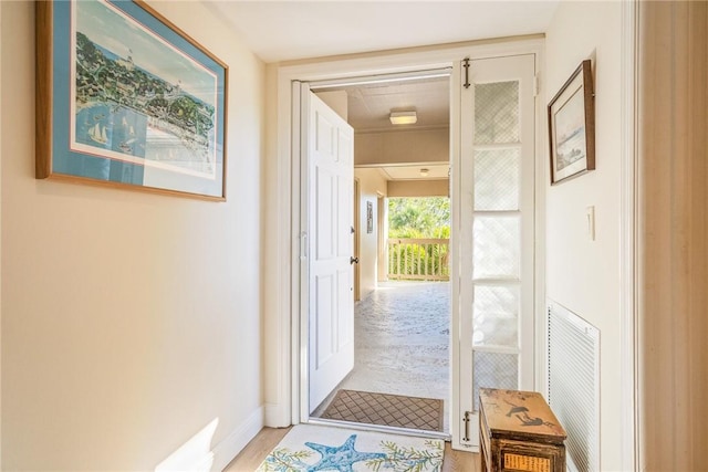 entryway with visible vents, baseboards, and light wood-style flooring