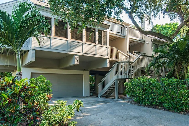 110 Amy Ann Ln, Vero Beach, FL 32963 - view of property featuring a garage, stairs, and concrete driveway