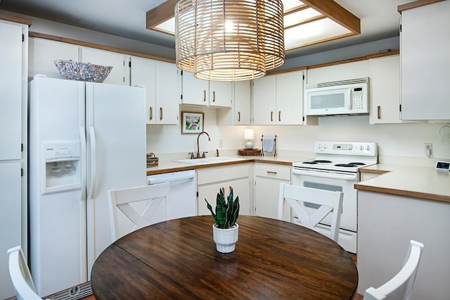 110 Amy Ann Ln, Vero Beach, FL 32963 - kitchen with white appliances, a sink, white cabinetry, and light countertops