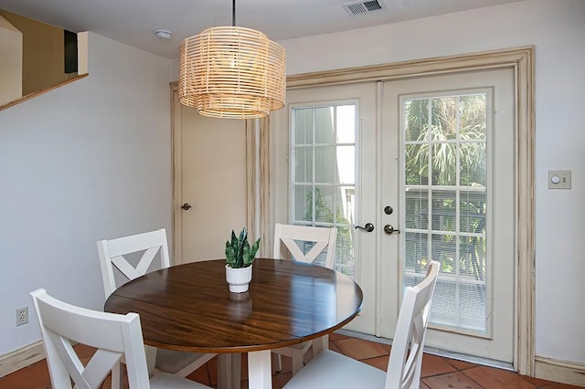 110 Amy Ann Ln, Vero Beach, FL 32963 - dining room featuring a chandelier, french doors, and tile patterned flooring