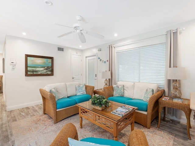 living room with ceiling fan and light hardwood / wood-style flooring