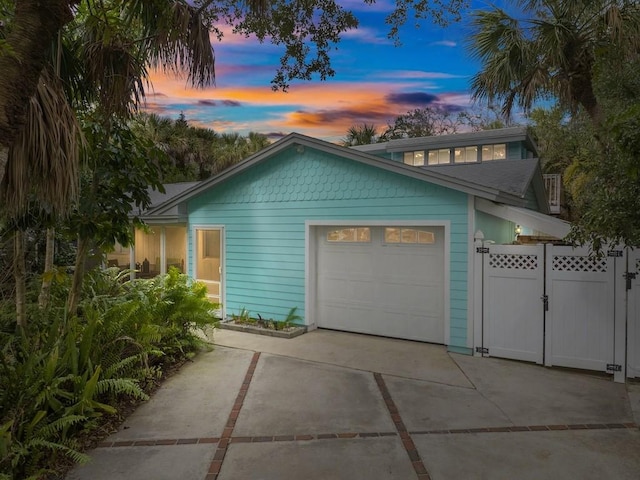 property exterior at dusk featuring a garage