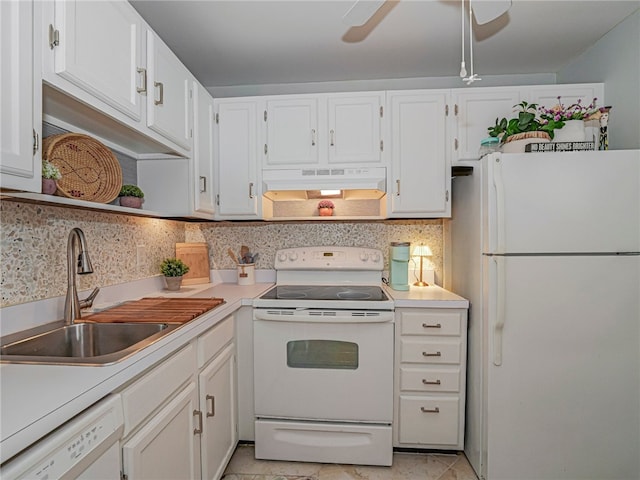 kitchen featuring under cabinet range hood, white appliances, a sink, white cabinets, and light countertops