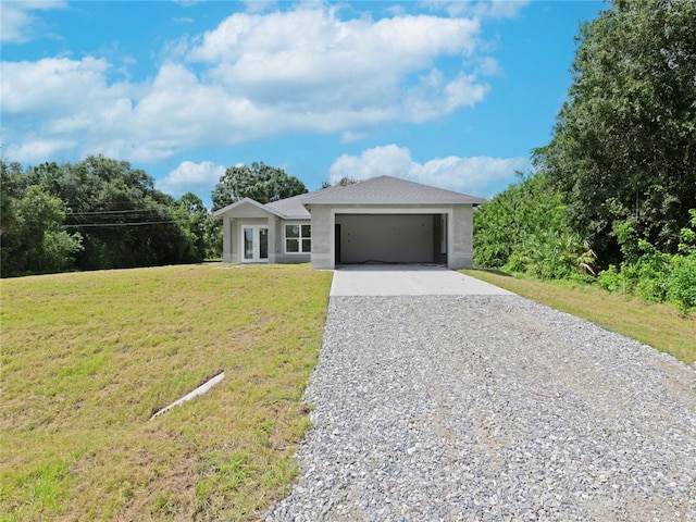 view of front of property with a garage and a front lawn