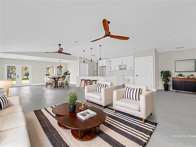 living room featuring french doors and vaulted ceiling