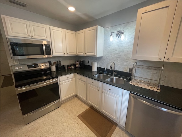 kitchen with white cabinets, sink, and appliances with stainless steel finishes