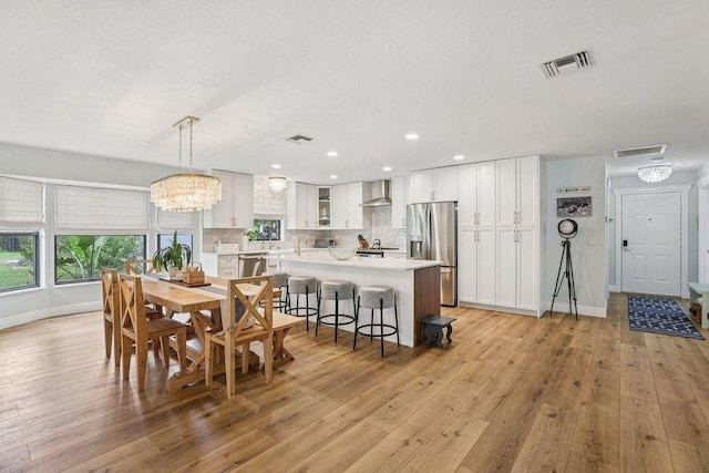 9830 Oak Trl, Sebastian, FL 32976 - dining area with light wood-style floors, recessed lighting, and a chandelier