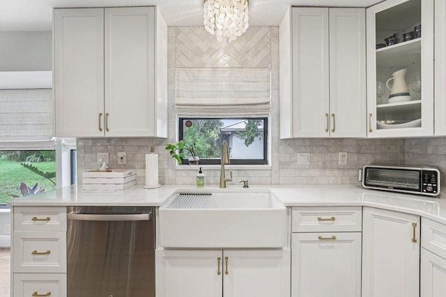 9830 Oak Trl, Sebastian, FL 32976 - kitchen with dishwasher, backsplash, light countertops, and white cabinetry