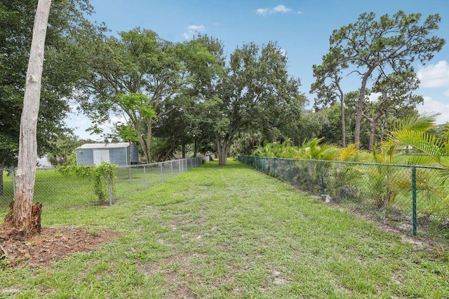 9830 Oak Trl, Sebastian, FL 32976 - fenced backyard featuring a storage unit