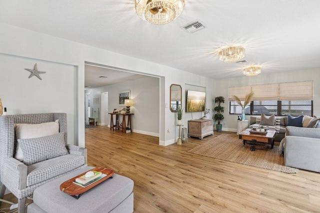 9830 Oak Trl, Sebastian, FL 32976 - living area featuring a chandelier and light wood finished floors