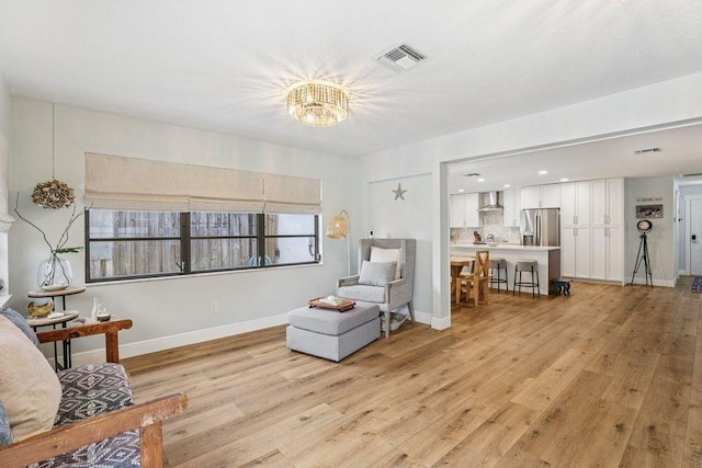 9830 Oak Trl, Sebastian, FL 32976 - living area with light wood-type flooring, a chandelier, and recessed lighting