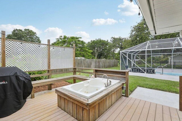 9830 Oak Trl, Sebastian, FL 32976 - deck with a lanai, a grill, a fenced backyard, and an outdoor pool