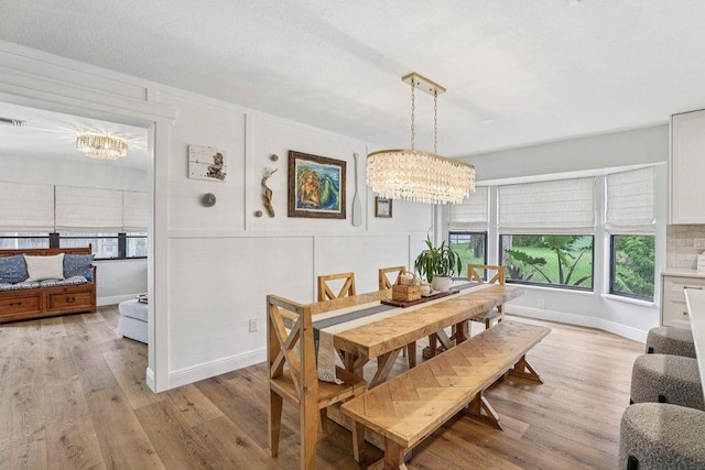 9830 Oak Trl, Sebastian, FL 32976 - dining room featuring a chandelier, light wood-type flooring, and plenty of natural light