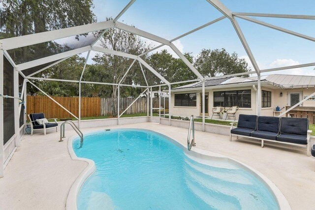 9830 Oak Trl, Sebastian, FL 32976 - view of swimming pool with a patio area, an outdoor hangout area, a fenced backyard, and a lanai